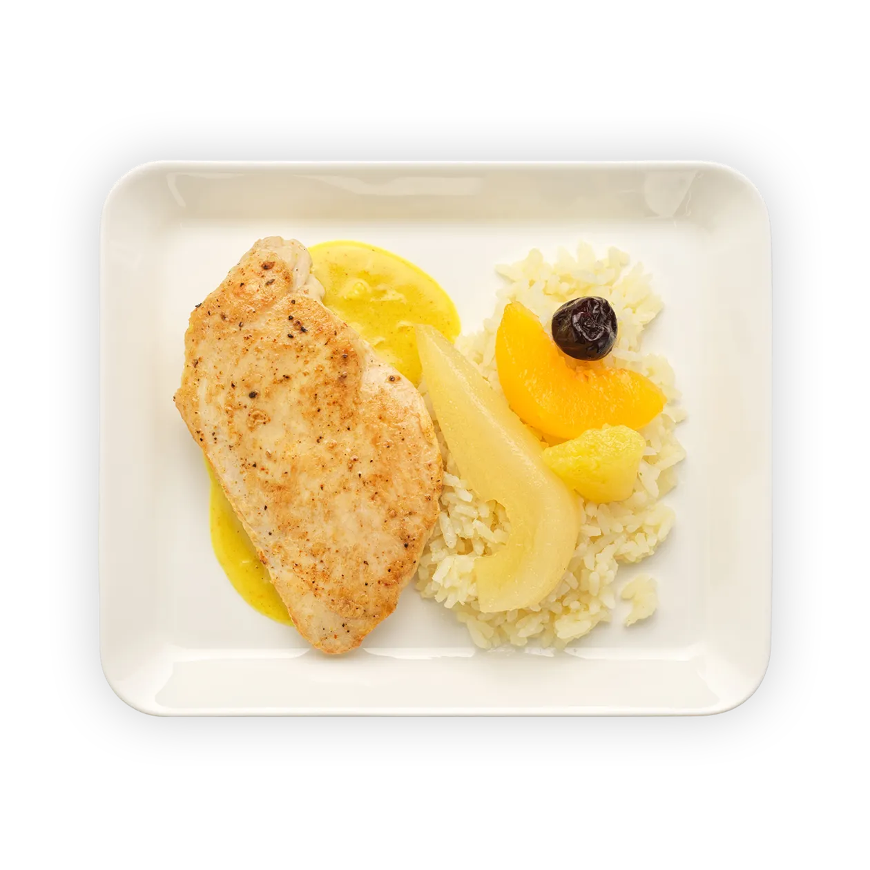 Chicken breast with Casimir curry sauce | creamy rice pilaf and fruit garnish