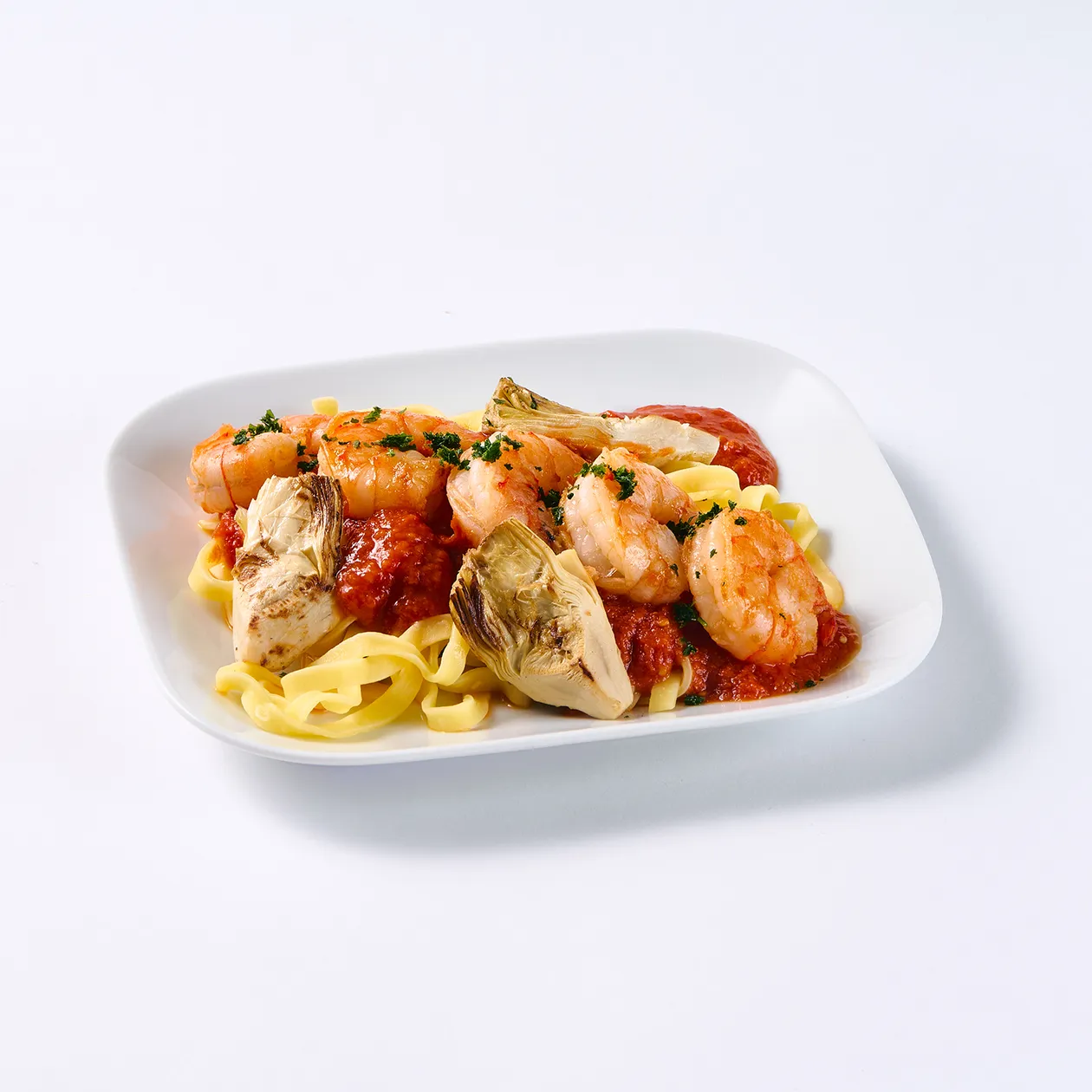 Prawns with tagliatelle pasta, tomato sauce, artichokes and parsley